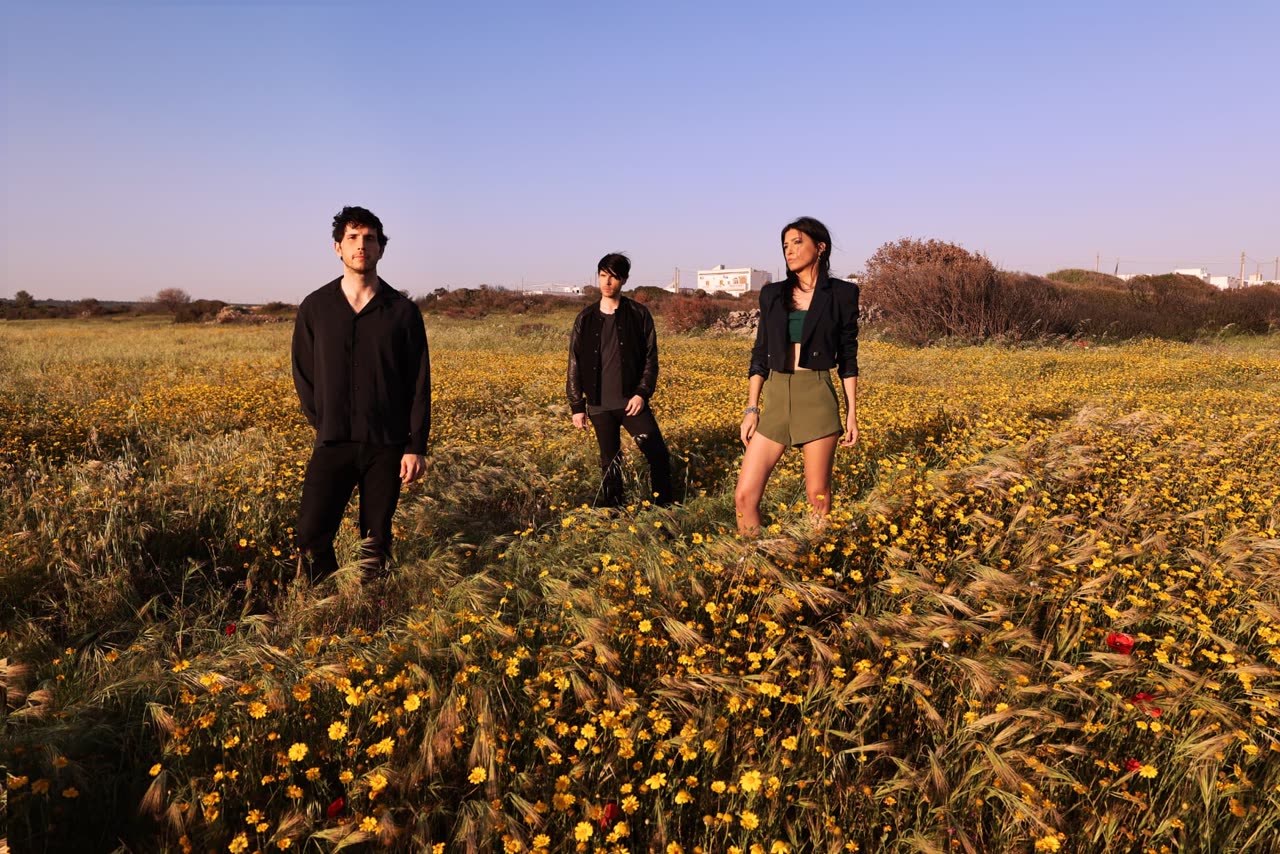 Miccoli, the British-Italian alternative sibling band, photographed in moody low light