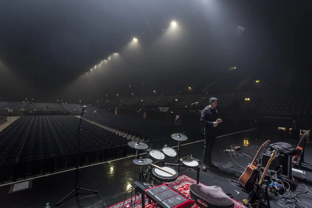 Miccoli preparing onstage inside a UK arena